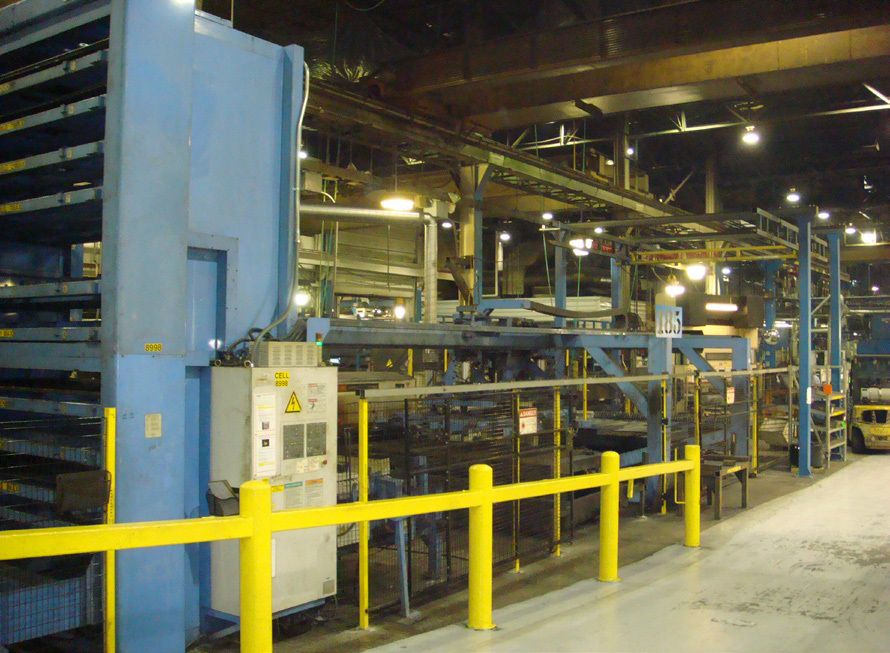 Laser-cutting machines are shown in a manufacturing environment