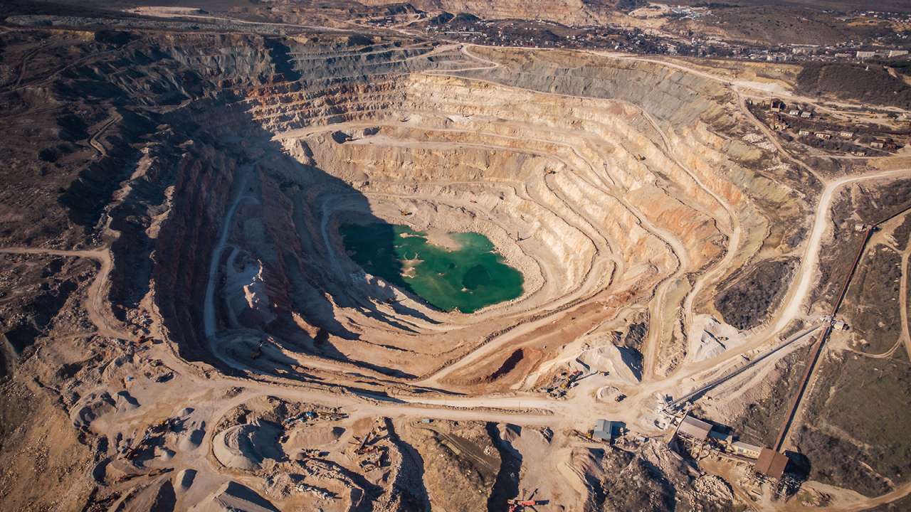 Open cast quarry for digging and production of flux limestone, gravel material, crushed stone and sand, aerial view. Mining  industry
