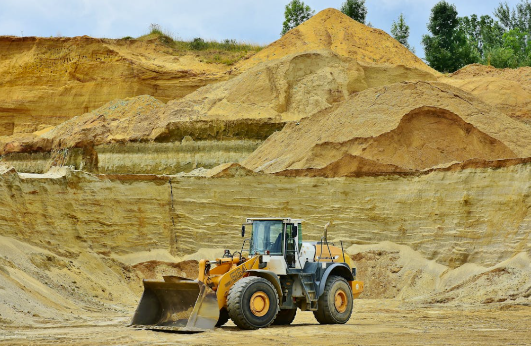 Aerial view of open cast quarry for digging and production of flux limestone, gravel material, crushed stone, and sand.