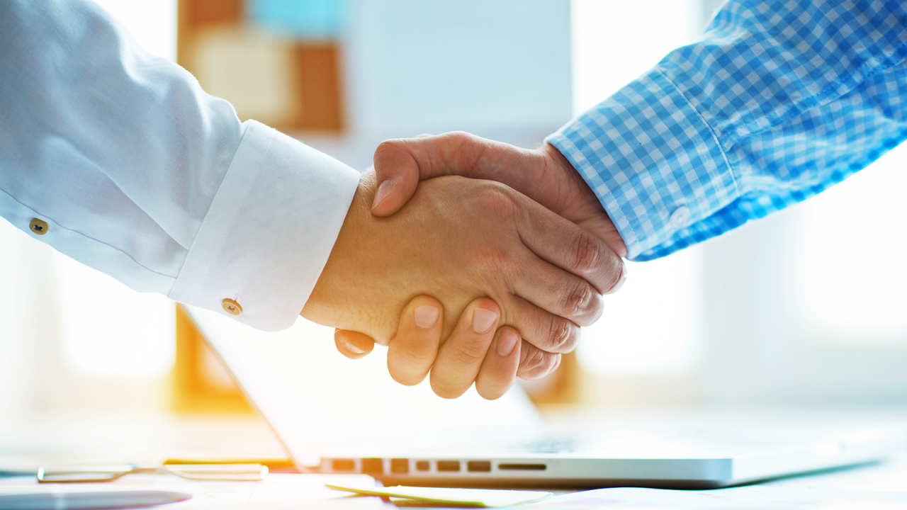 businessmen shaking hands in the office.